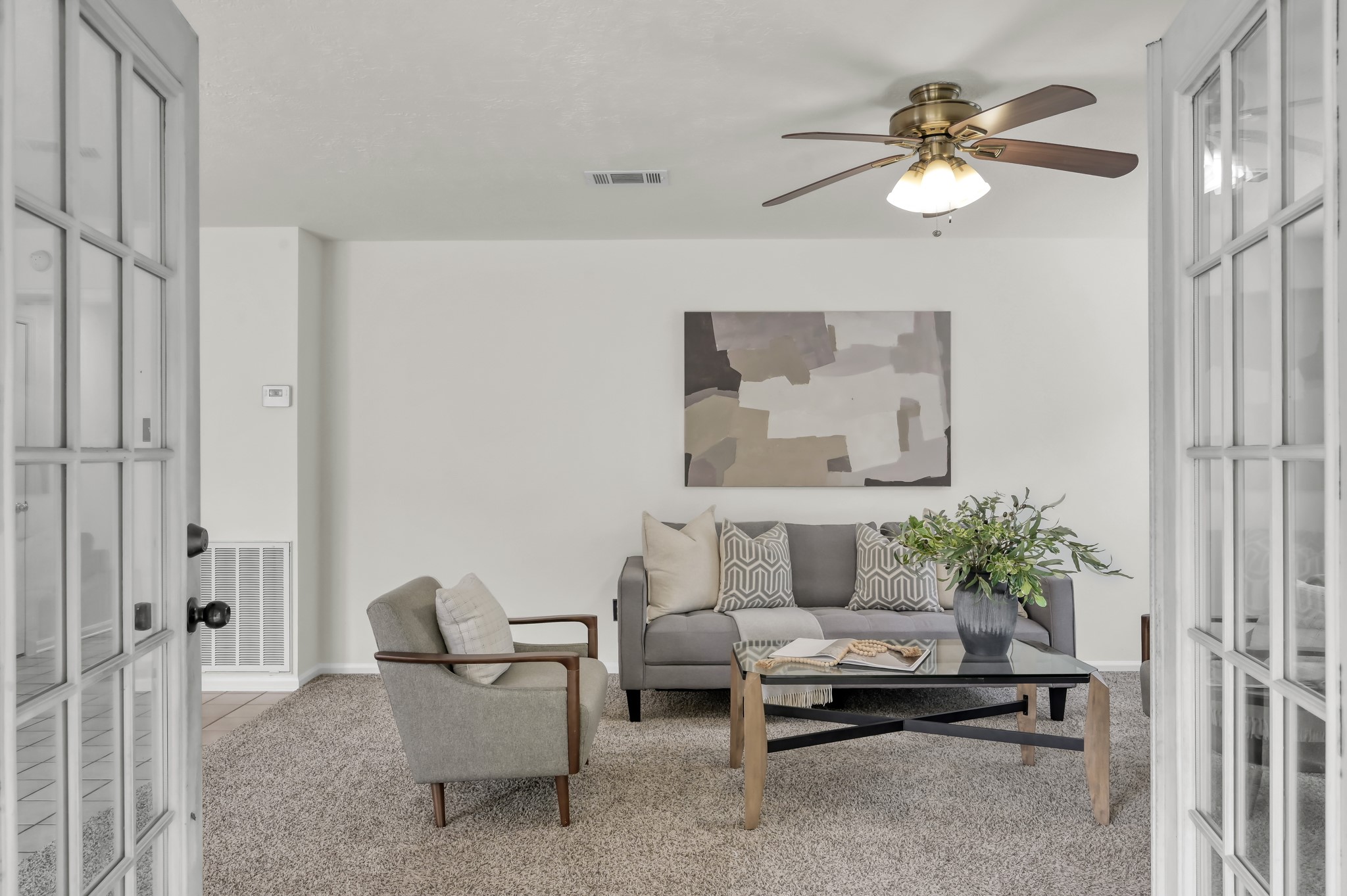 114 Regency Way Conroe, TX 77304 - Photo 14 of 48 Spacious, light and bright living room with cozy wood/gas fire place, double doors leading to covered back patio and ceiling fan.
