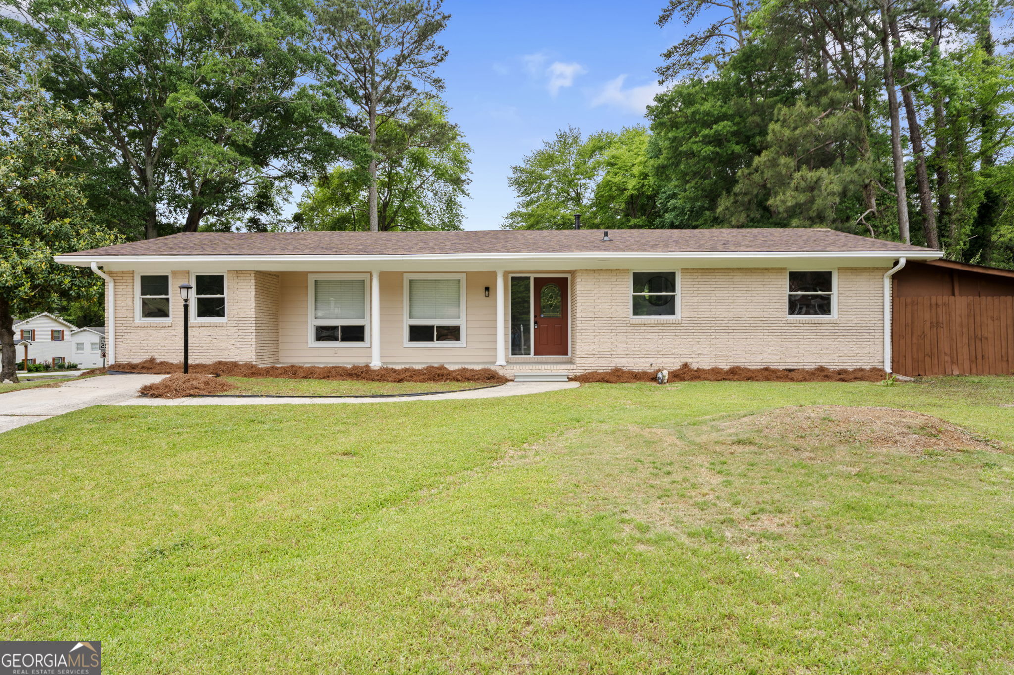 6463 Maddox Road Morrow, GA 30260 - Photo 1 of 46 a backyard of a house with table and chairs
