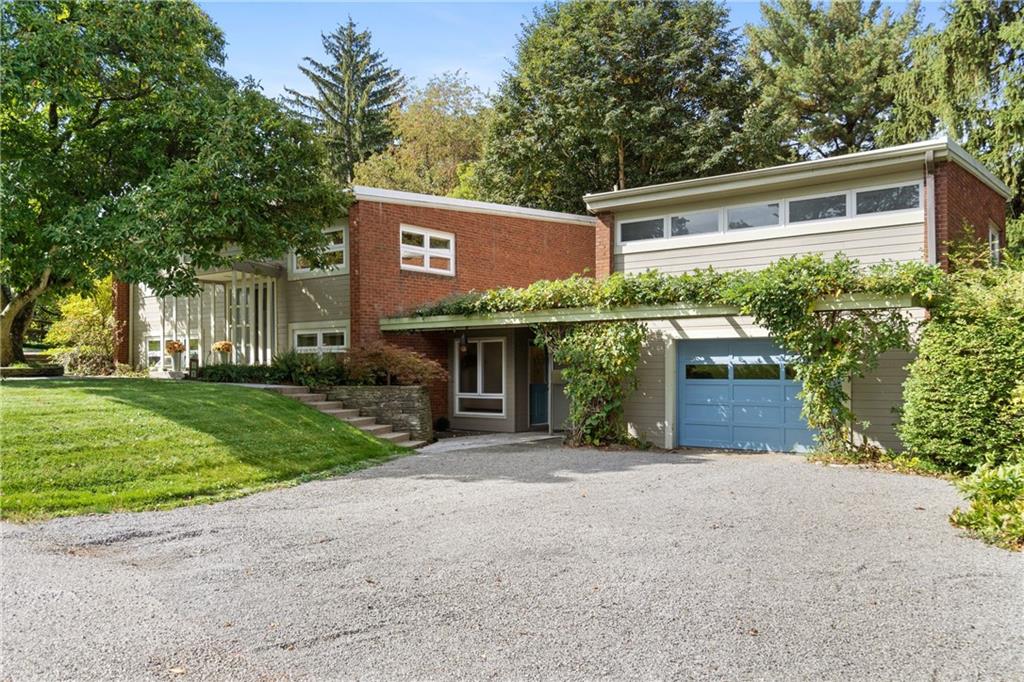 a view of a house with a yard and garage