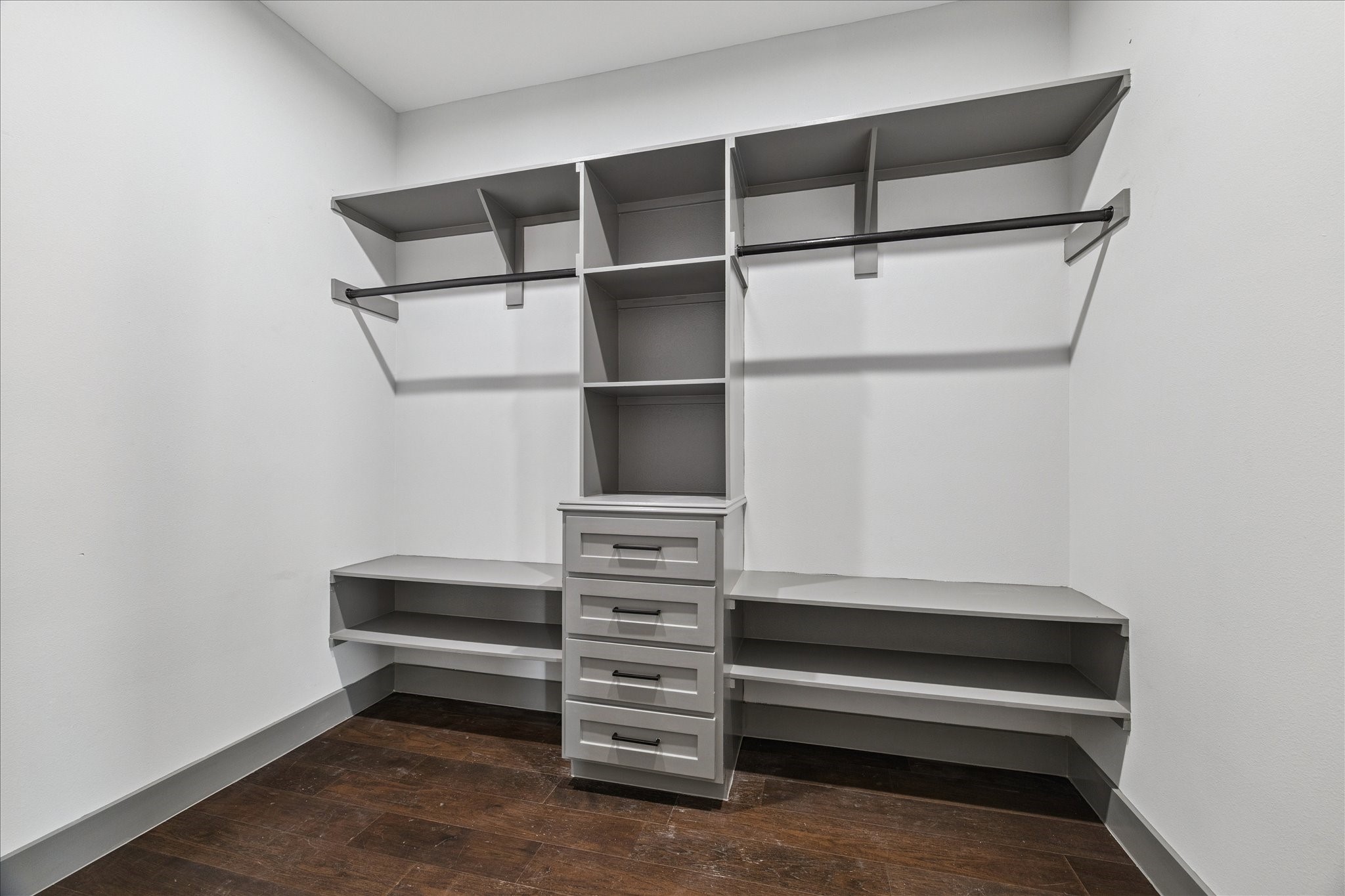 2323 Tuam Street Houston, TX 77004 - Photo 17 of 24 Shelves, drawers, and double hanging rods in the custom closet create an organized, versatile space for clothing, shoes, and accessories.