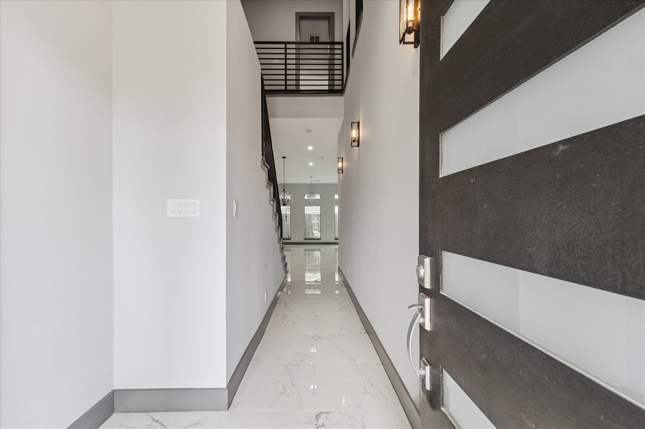 2323 Tuam Street Houston, TX 77004 - Photo 2 of 24 A bright, open ambiance greets you in the foyer, where tile flooring extends across the main level and the staircase with upper railing draws the eye upward for added dimension.