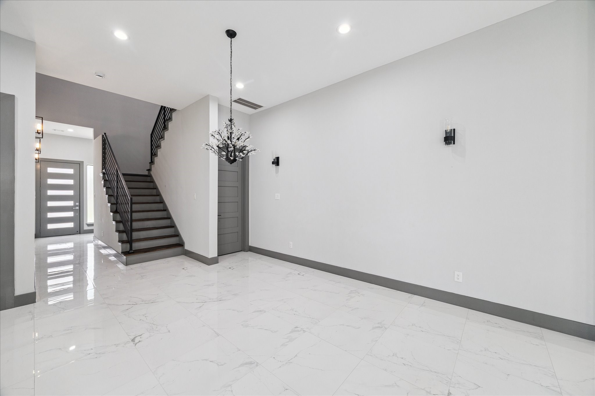 2323 Tuam Street Houston, TX 77004 - Photo 4 of 24 Sleek tile flooring, clean lines, and contemporary lighting create a welcoming space that connects the front entry to the heart of the home.