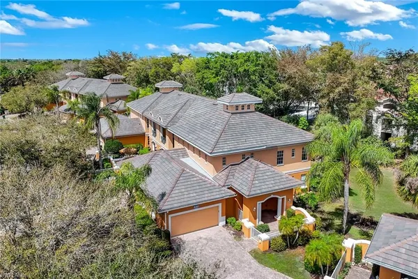 an aerial view of a house with a yard table and chairs