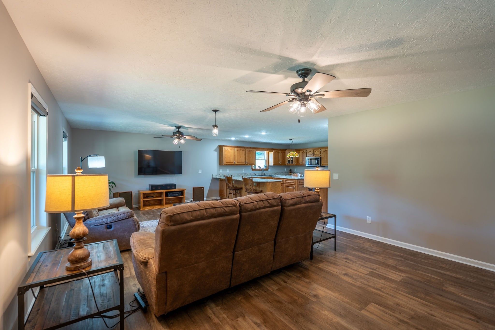 6285 Rayburn Creek Road Collinwood, TN 38450 - Photo 13 of 51 a living room with furniture a ceiling fan and a flat screen tv