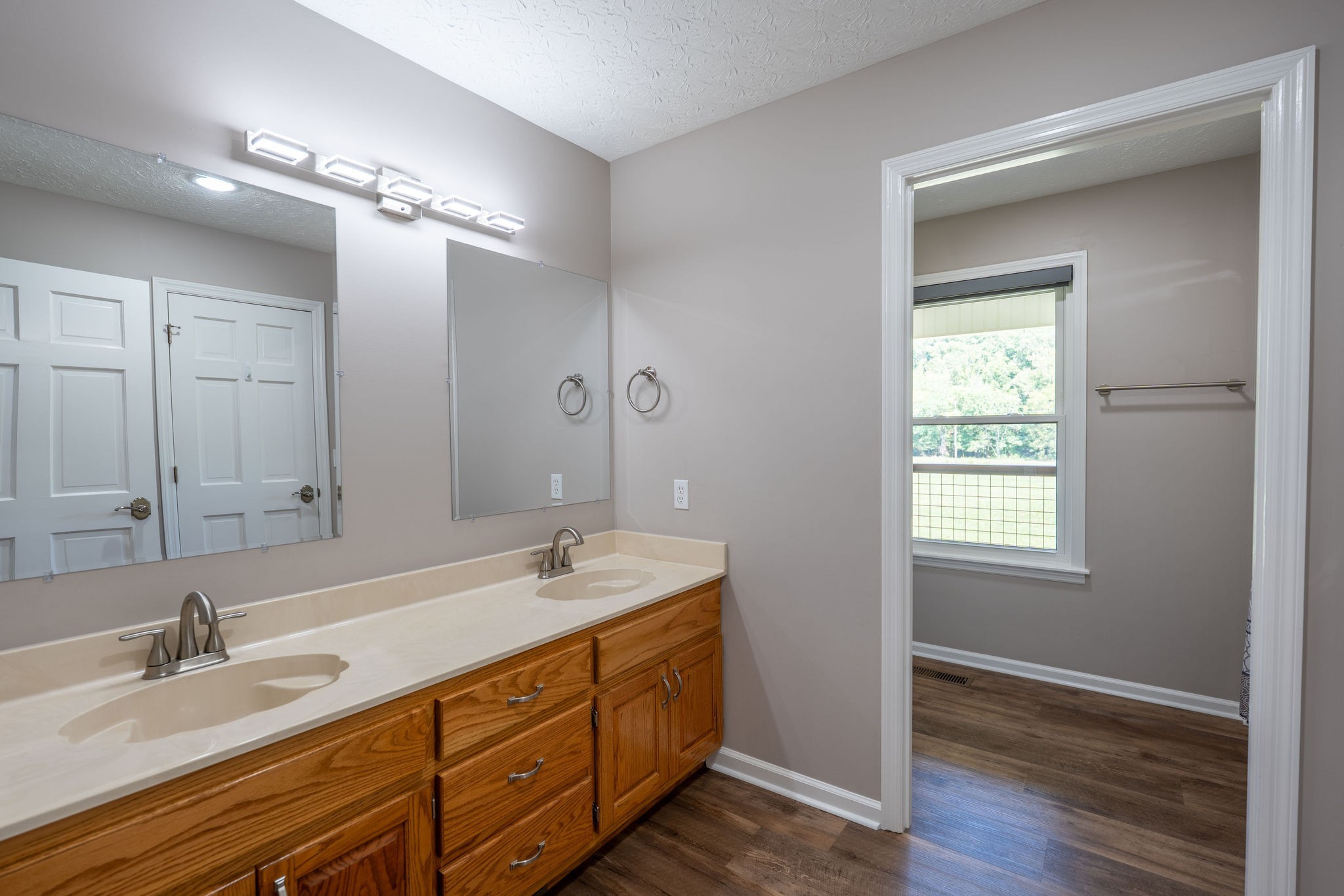 6285 Rayburn Creek Road Collinwood, TN 38450 - Photo 17 of 51 a bathroom with double vanity sinks and a mirror
