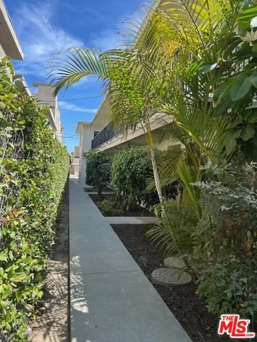 a view of building with car parked