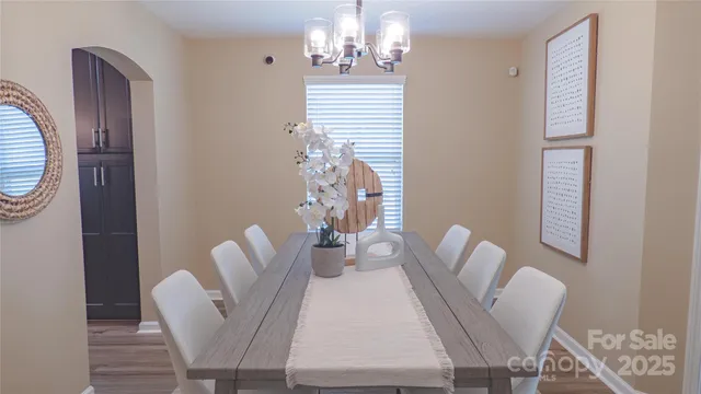 a view of a dining room with furniture wooden floor and chandelier