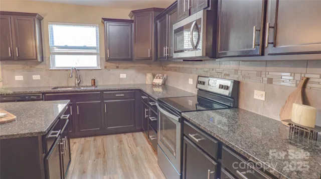 a living room with furniture a lamp paintings and a window