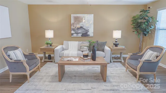 a living room with furniture a table and a potted plant
