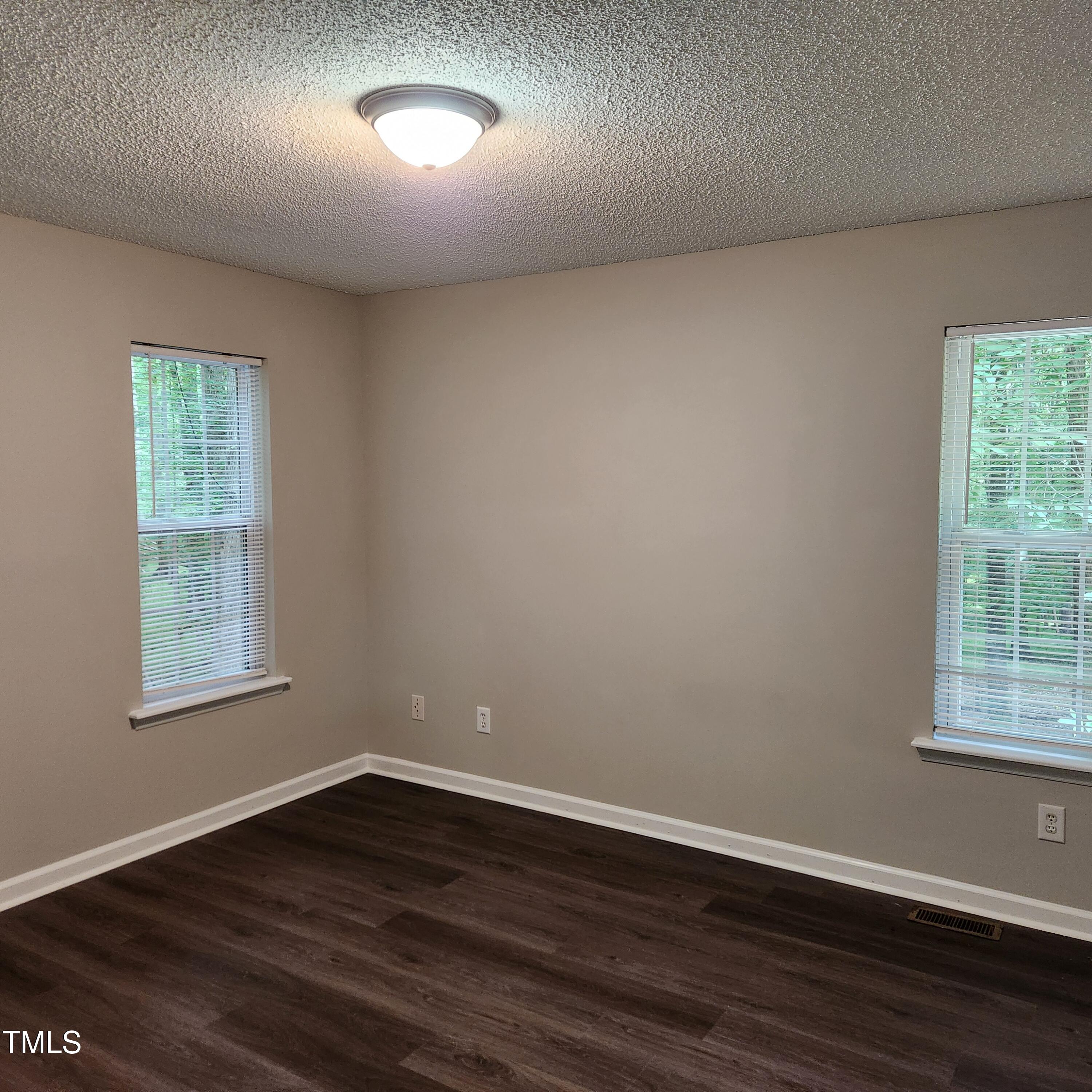 132 Waiters Way Youngsville, NC 27596 - Photo 11 of 30 an empty room with wooden floor and windows