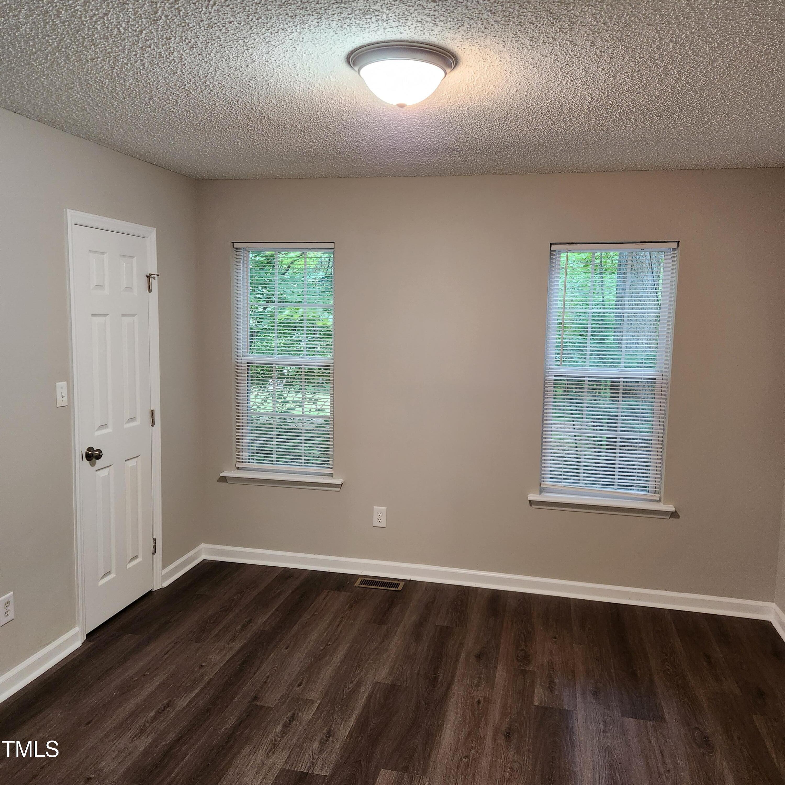 132 Waiters Way Youngsville, NC 27596 - Photo 13 of 30 an empty room with wooden floor and windows