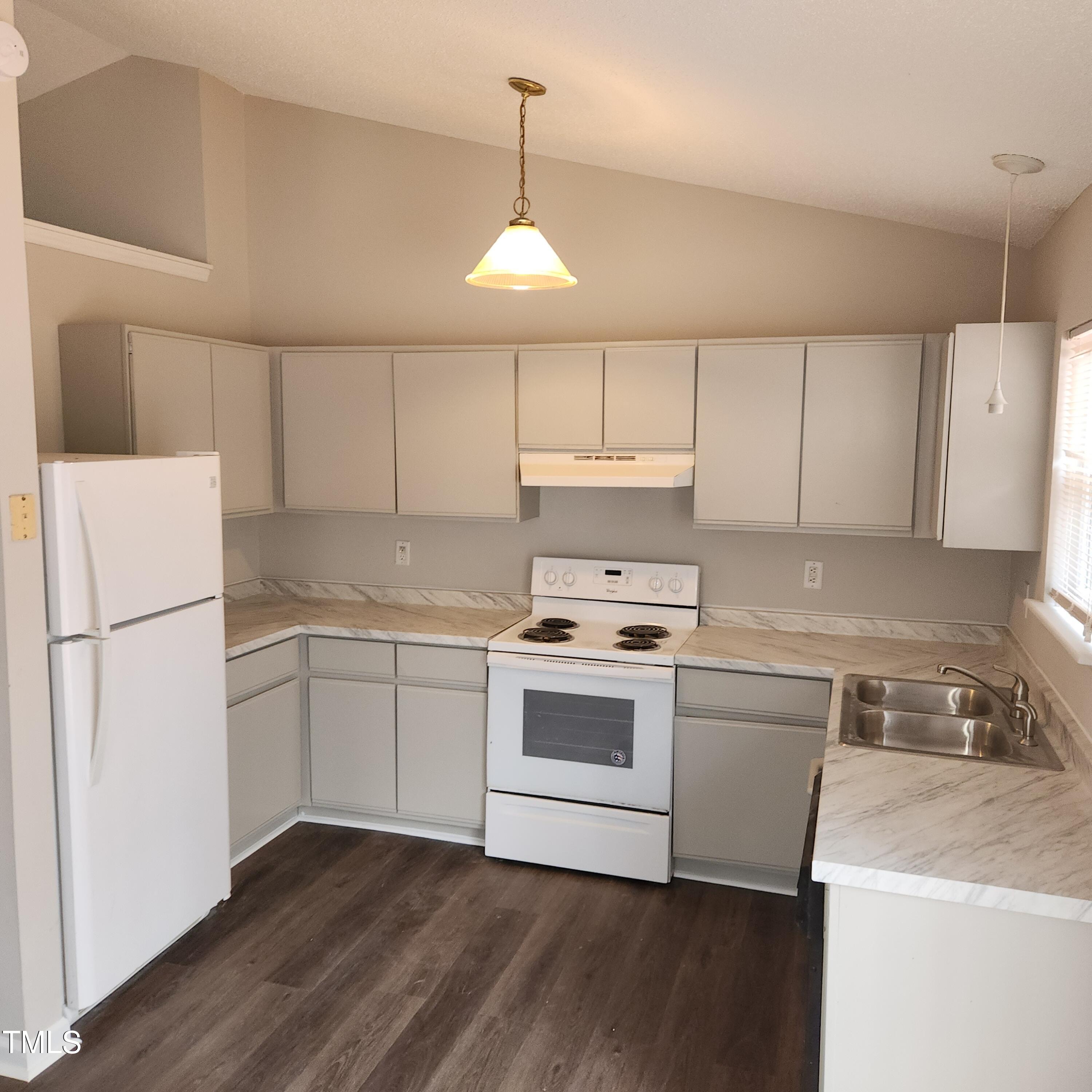 132 Waiters Way Youngsville, NC 27596 - Photo 15 of 30 a kitchen with a white cabinets and white appliances