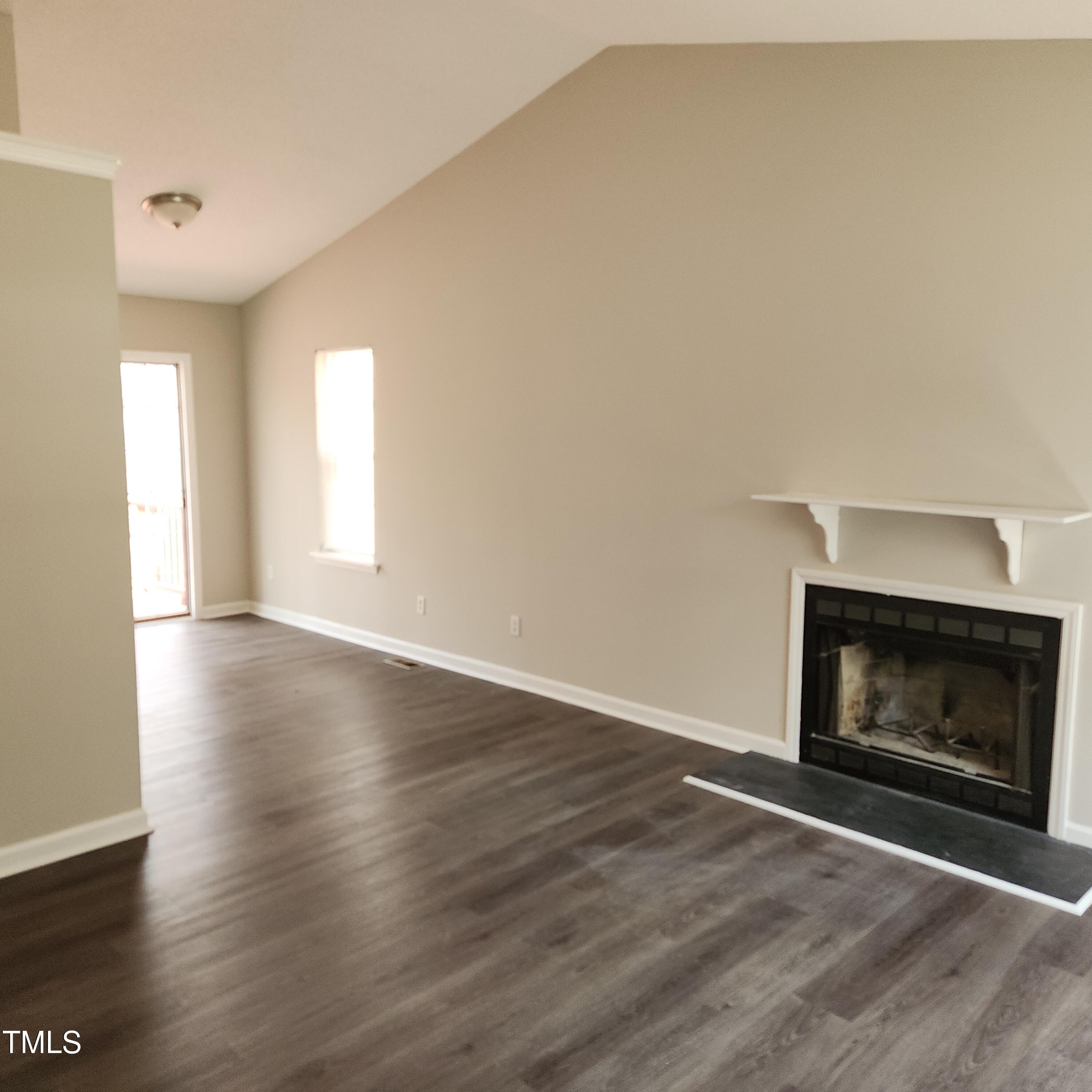 132 Waiters Way Youngsville, NC 27596 - Photo 20 of 30 a view of an empty room with wooden floor fireplace and a window