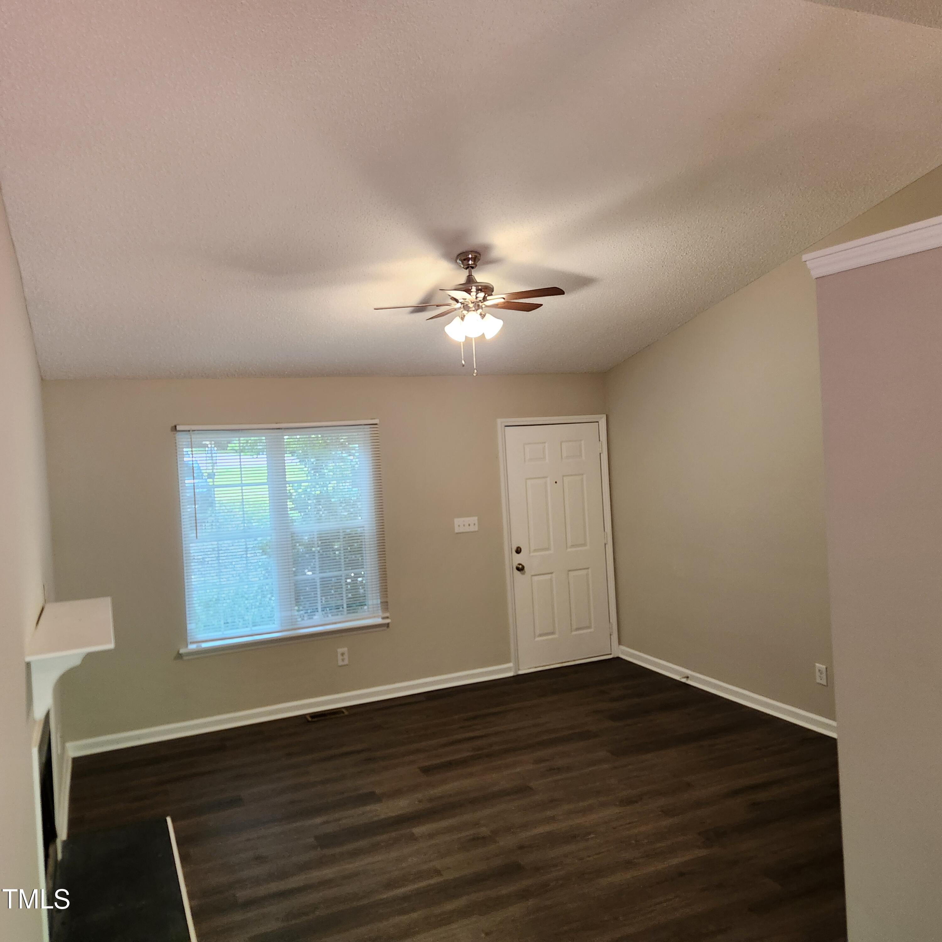 132 Waiters Way Youngsville, NC 27596 - Photo 3 of 30 a view of an empty room with wooden floor and a ceiling fan