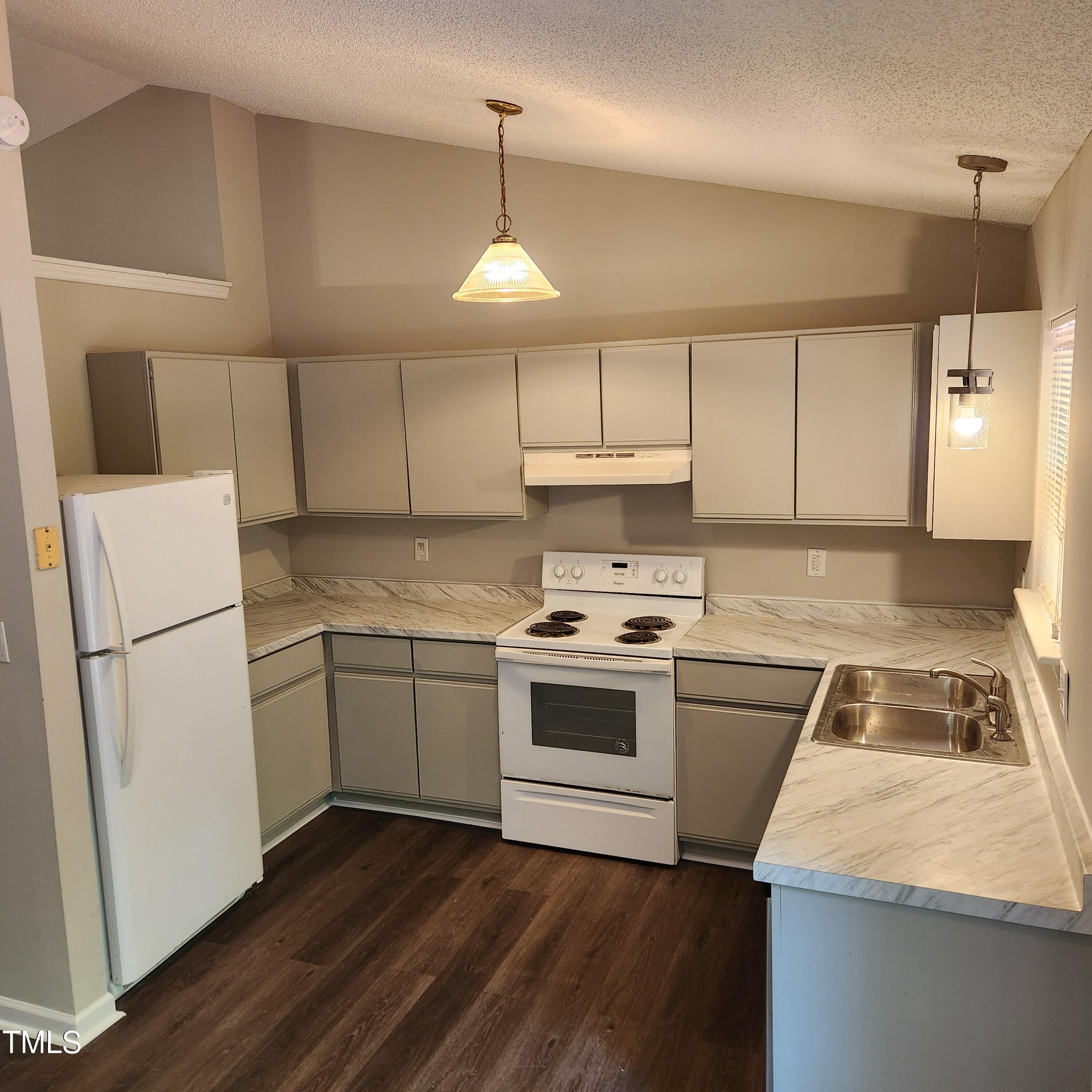 132 Waiters Way Youngsville, NC 27596 - Photo 4 of 30 a kitchen with a stove a sink and a refrigerator