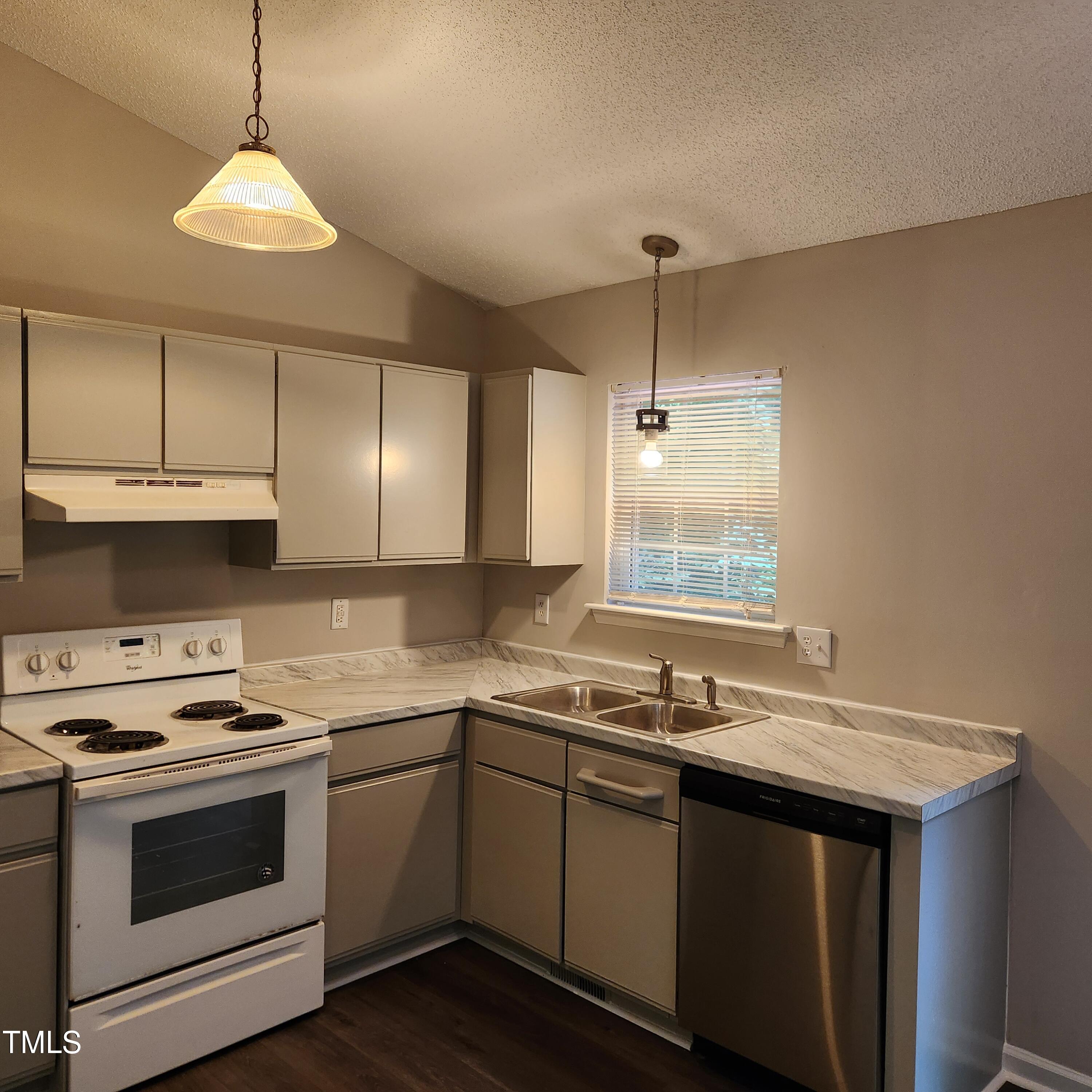 132 Waiters Way Youngsville, NC 27596 - Photo 5 of 30 a kitchen with a sink stove and cabinets