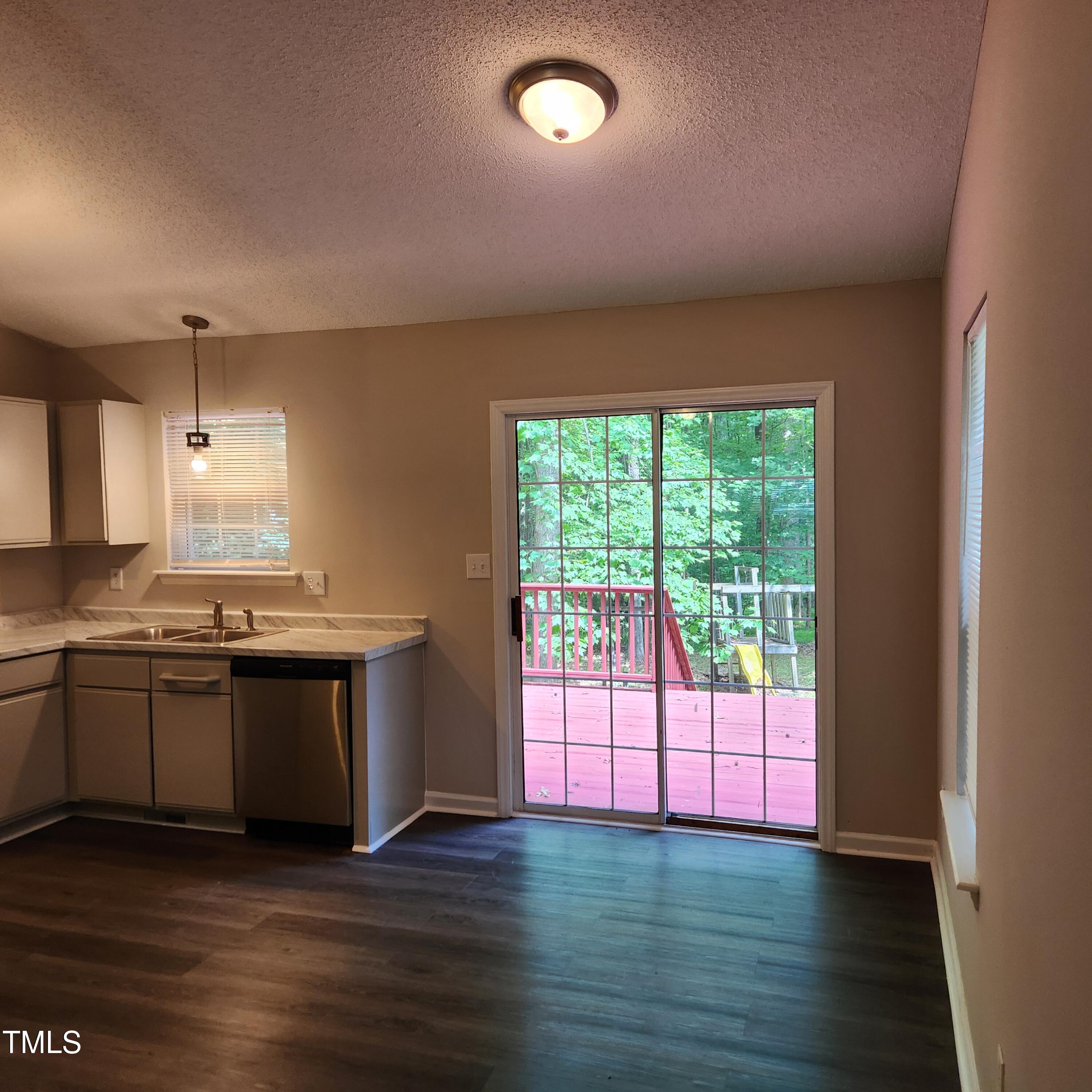132 Waiters Way Youngsville, NC 27596 - Photo 6 of 30 a large kitchen with stainless steel appliances granite countertop a stove and a large window