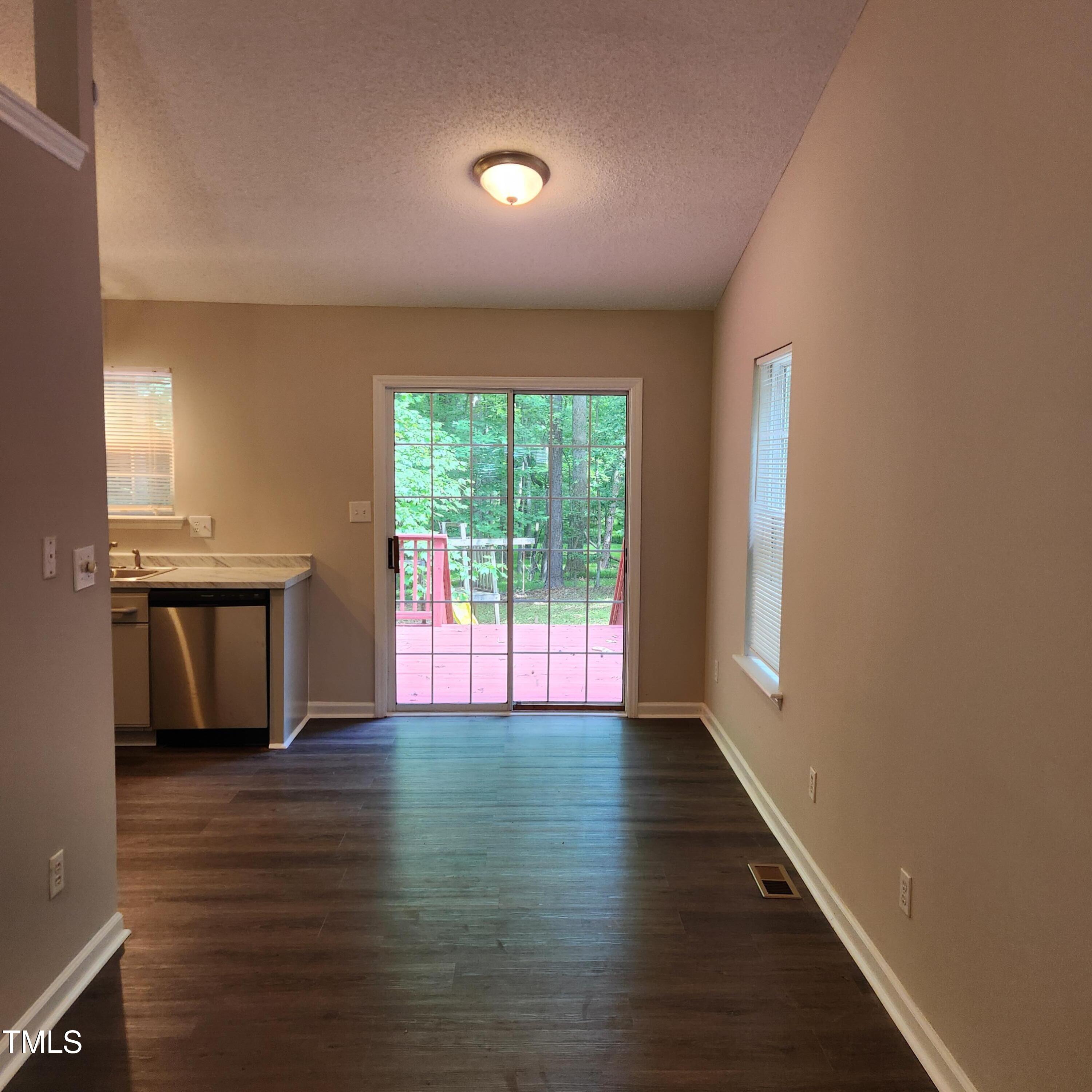 132 Waiters Way Youngsville, NC 27596 - Photo 7 of 30 an empty room with wooden floor and windows