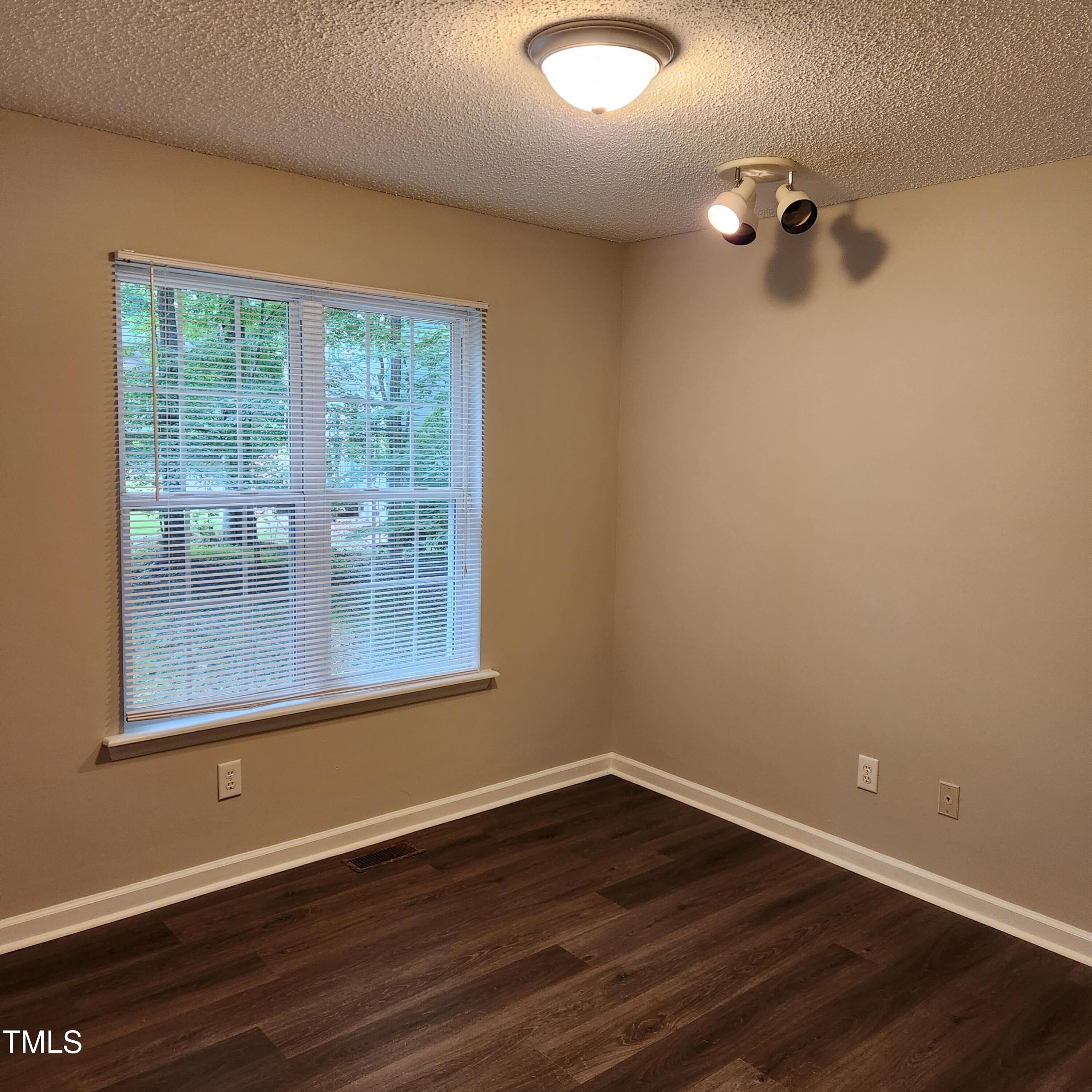 132 Waiters Way Youngsville, NC 27596 - Photo 9 of 30 a view of a room with wooden floor and windows