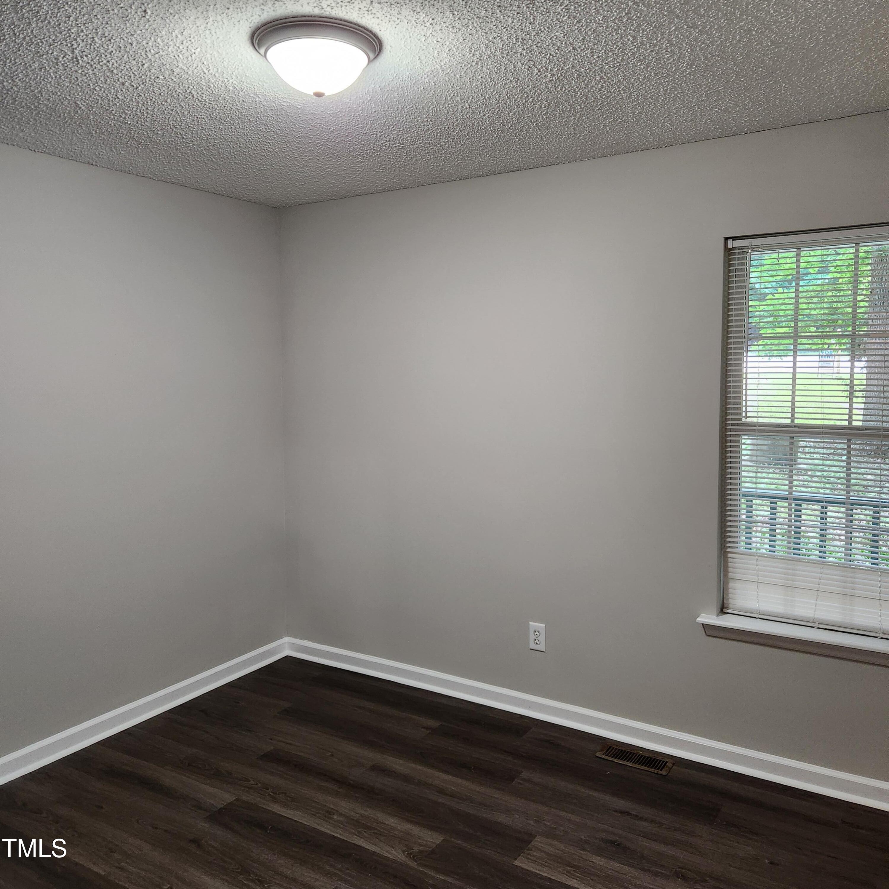 132 Waiters Way Youngsville, NC 27596 - Photo 10 of 30 a view of an empty room with wooden floor and a window