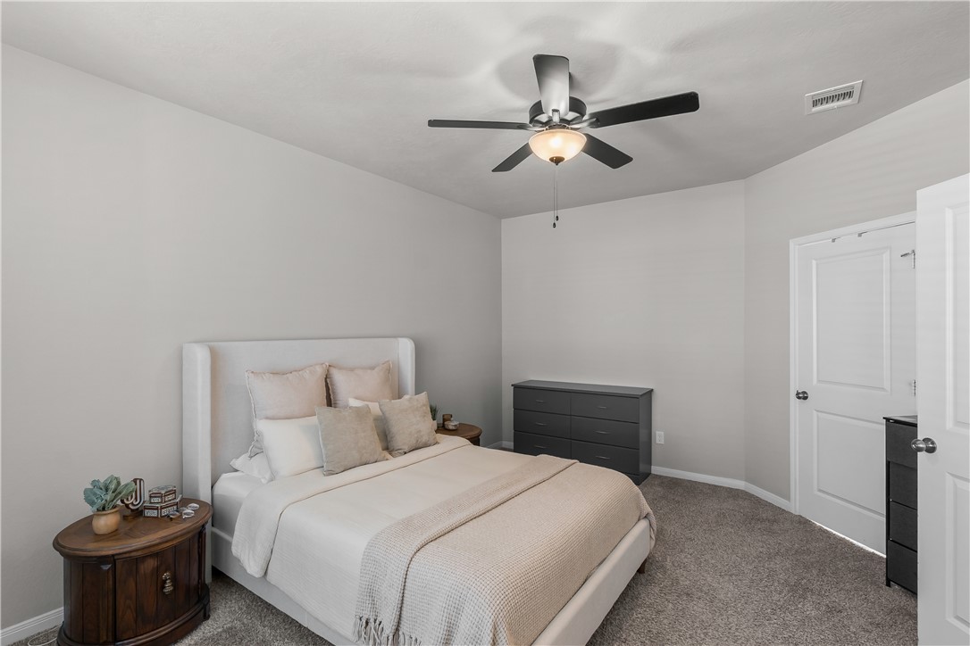 1925 Viva Road Bryan, TX 77807 - Photo 15 of 25 Carpeted bedroom featuring ceiling fan and baseboards