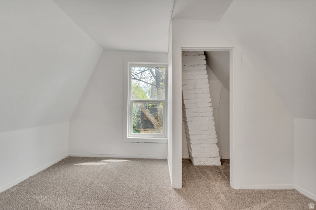 8831 South 400 East Sandy, UT 84070 - Photo 25 of 26 Bonus room with light colored carpet and vaulted ceiling