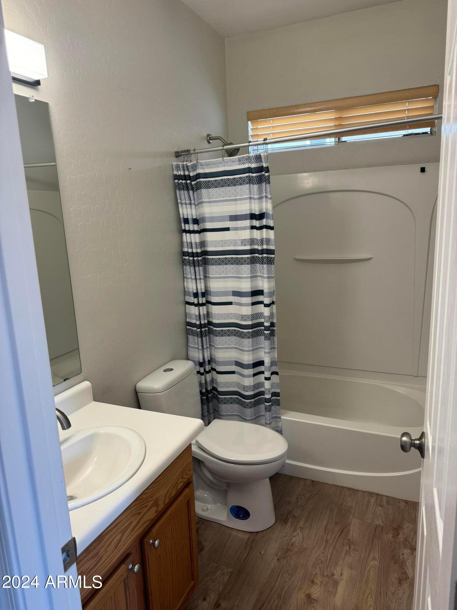 446 North Alder Court Gilbert, AZ 85233 - Photo 14 of 25 a bathroom with a toilet a sink and a shower