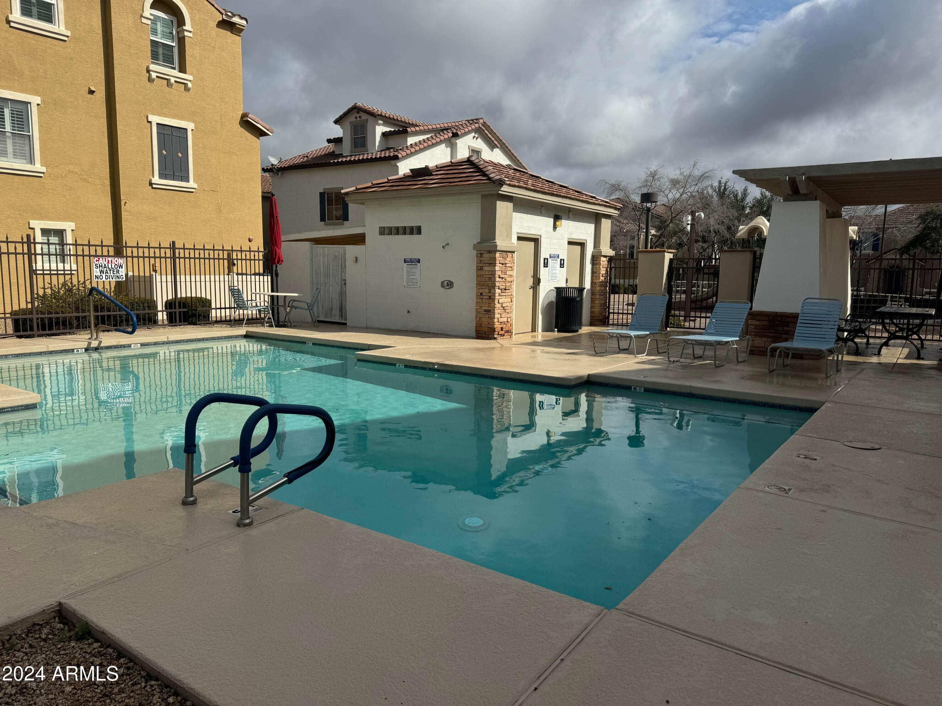 446 North Alder Court Gilbert, AZ 85233 - Photo 25 of 25 a view of a swimming pool with a lounge chairs in patio