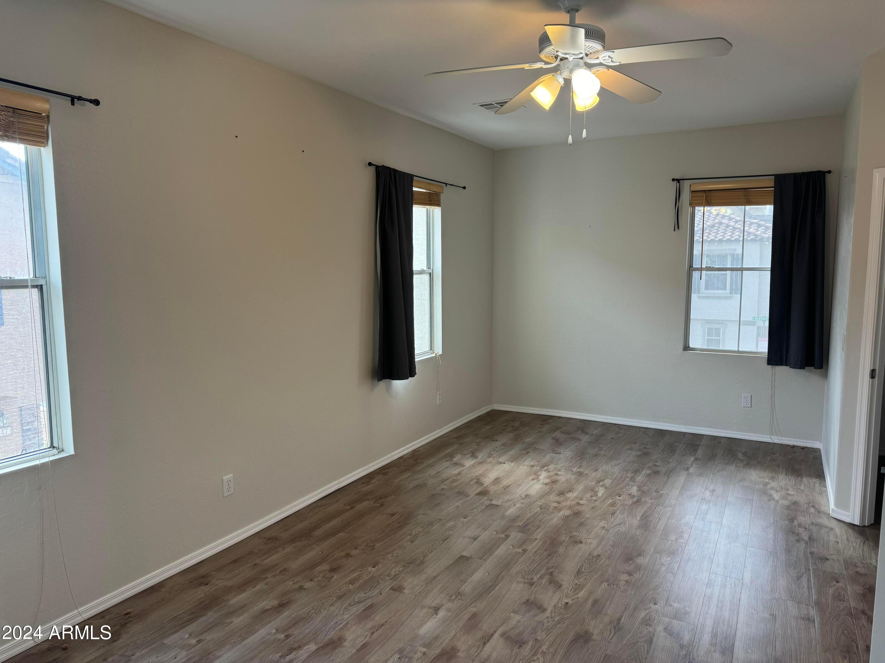 446 North Alder Court Gilbert, AZ 85233 - Photo 8 of 25 a view of an empty room with window and wooden floor