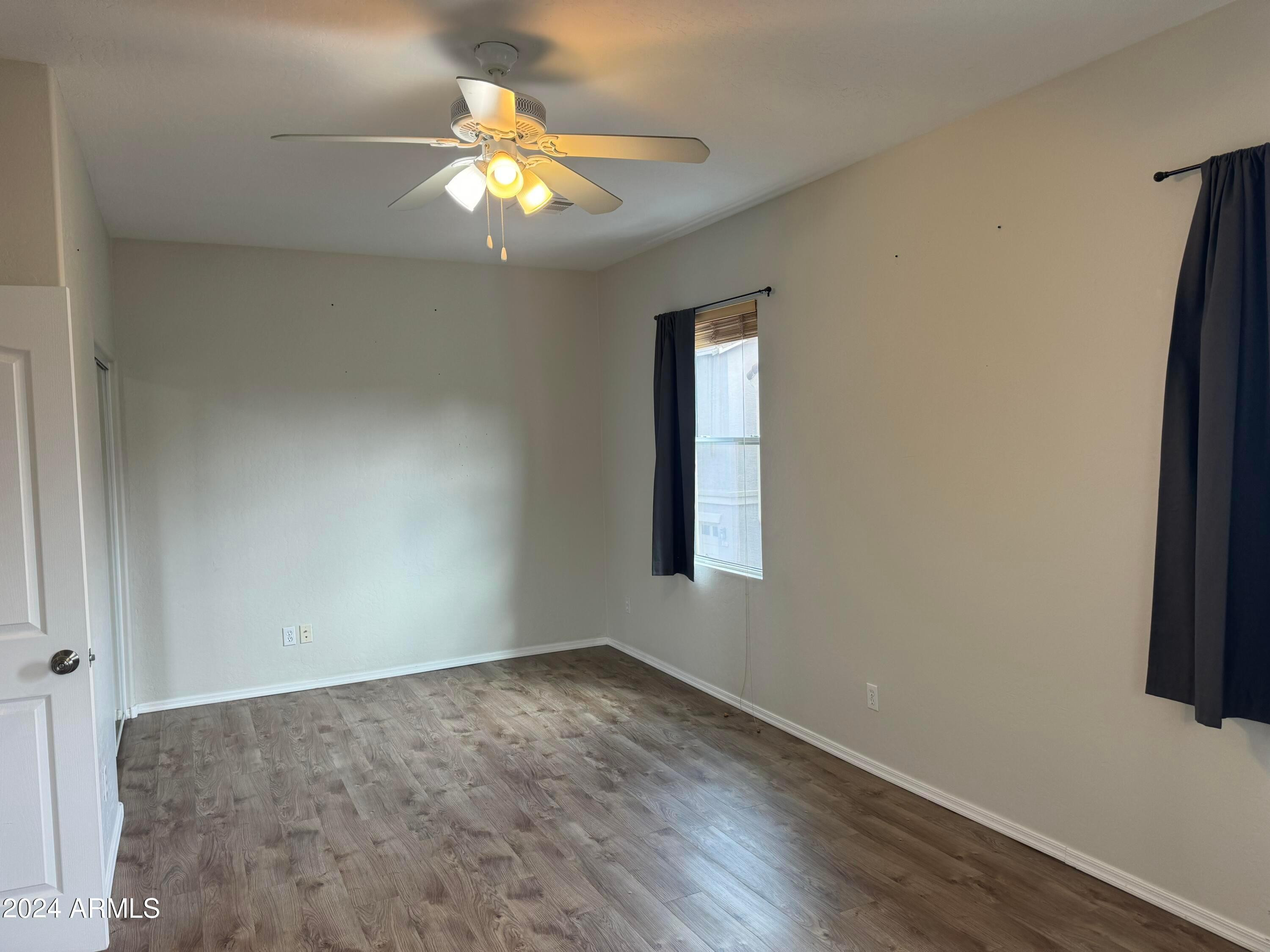446 North Alder Court Gilbert, AZ 85233 - Photo 9 of 25 an empty room with window and wooden floor