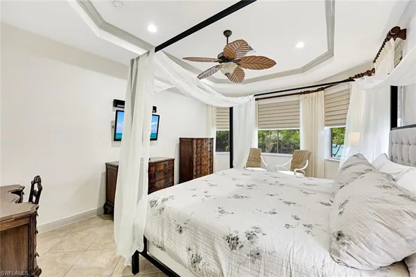 a large bedroom with a large bed and a large window