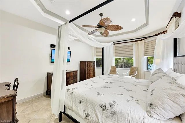 a large bedroom with a large bed and a large window