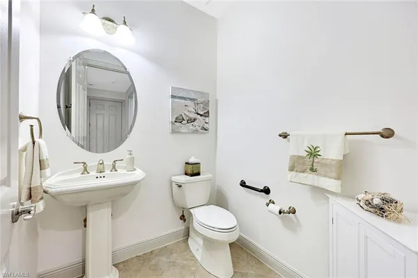 a bathroom with a sink toilet and a mirror
