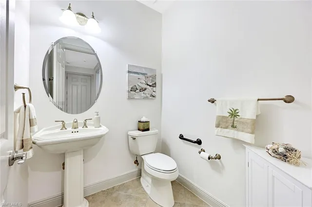 a bathroom with a sink toilet and a mirror