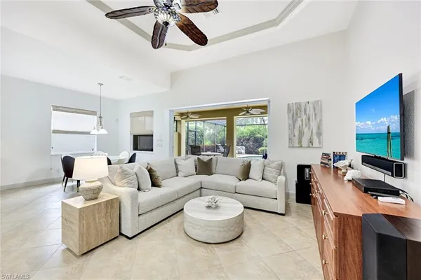 a living room with furniture a large window and a flat screen tv
