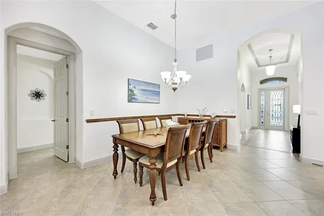 a view of a dining room with furniture and a chandelier