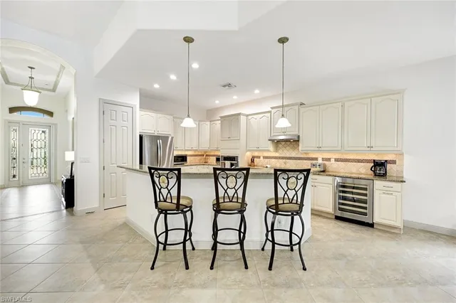 a large kitchen with a table and chairs