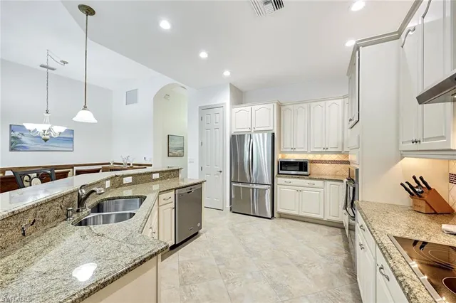 a kitchen with a refrigerator a sink and a stove