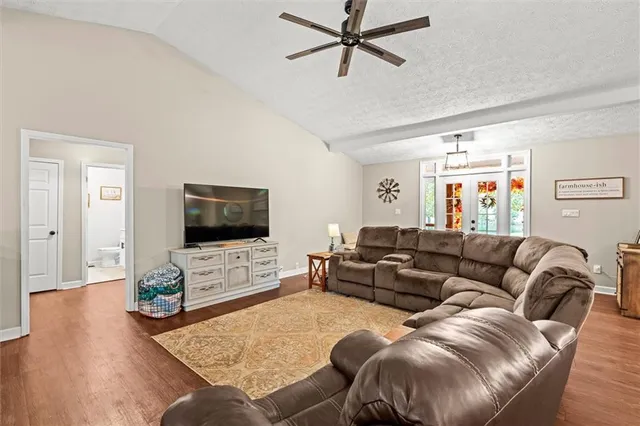 a living room with furniture and kitchen view