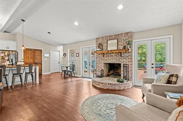 a living room with lots of furniture and wooden floor