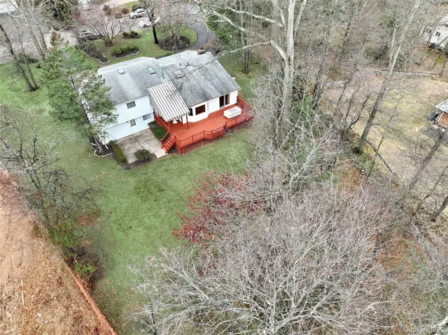 a backyard of a house with table and chairs