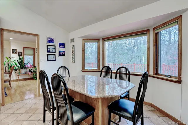 a dining room with furniture and window