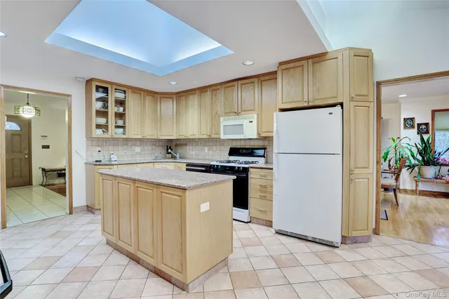 a kitchen with sink a refrigerator and a stove