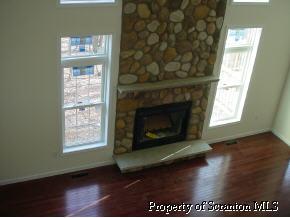 7 Pond Ridge Drive Scranton, PA 18504 - Photo 3 of 6 a living room with a fireplace and a window