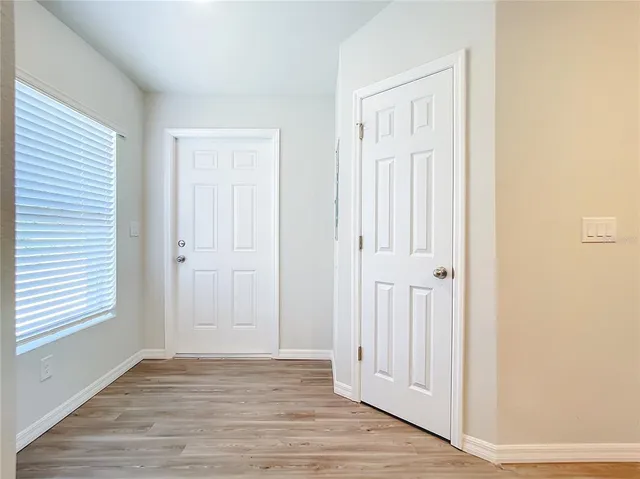 an empty room with wooden floor