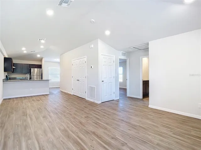 a view of kitchen with refrigerator and a window