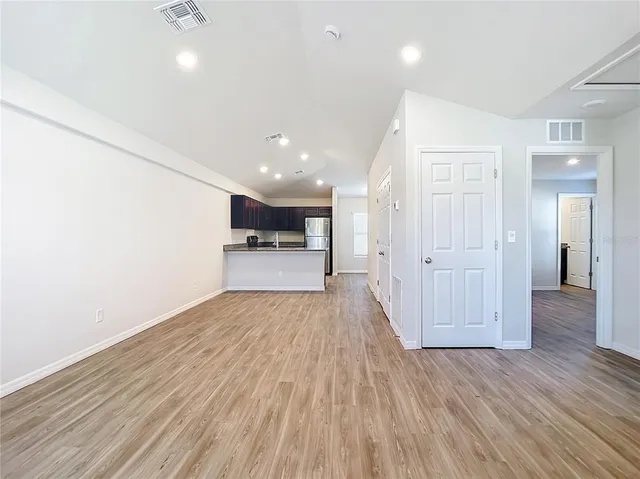 a view of a hallway with wooden floor