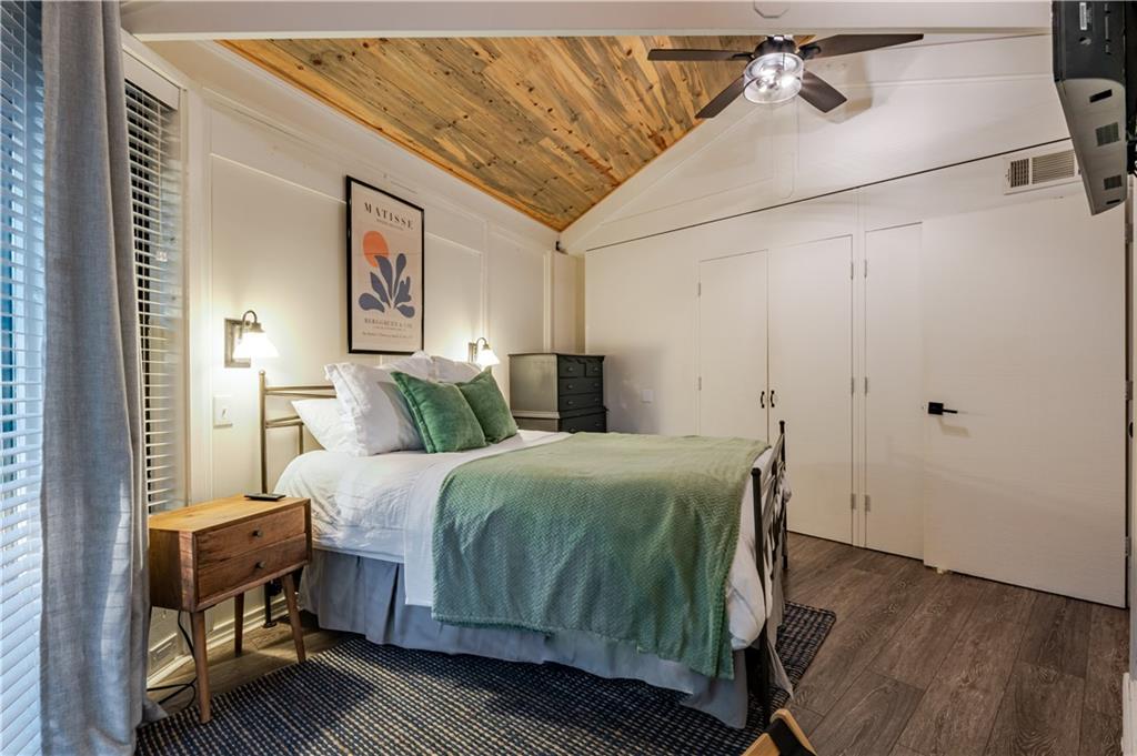150 Treetopper Circle Big Canoe, GA 30143 - Photo 14 of 26 a bedroom with a bed and wooden floor