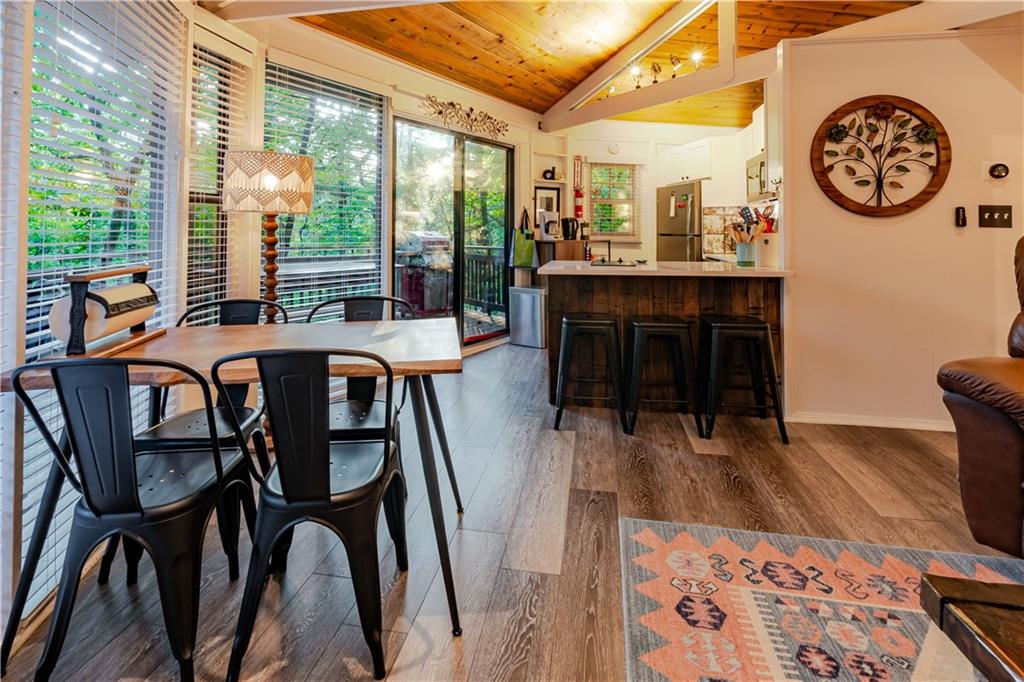 150 Treetopper Circle Big Canoe, GA 30143 - Photo 16 of 26 a view of a dining room with furniture window and wooden floor