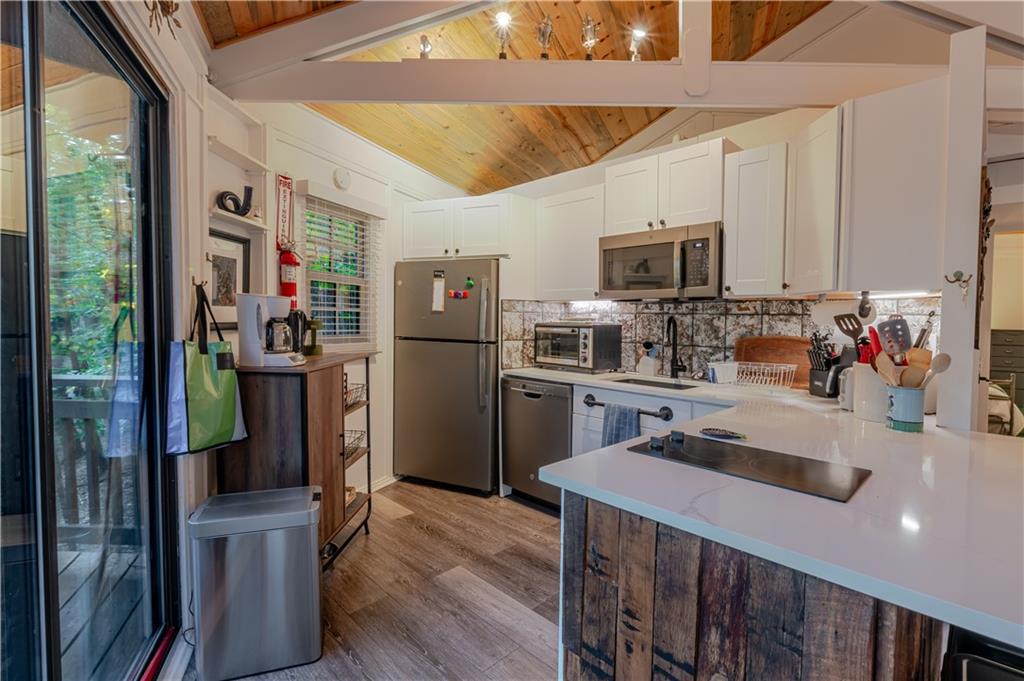 150 Treetopper Circle Big Canoe, GA 30143 - Photo 19 of 26 a kitchen with refrigerator and microwave